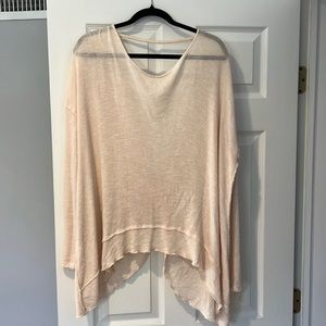 Light pink sweater with open back.